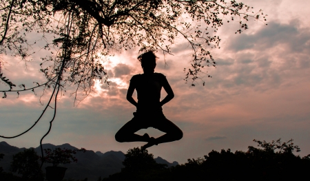 A woman jumping on the mountainの写真素材