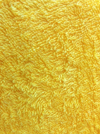 A fine texture of bright yellow bath towel.の写真素材
