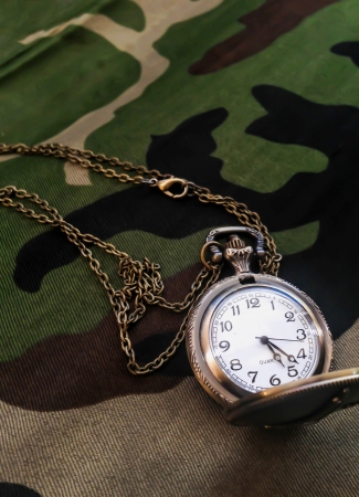 Pocket watch on Military fabric patternの写真素材