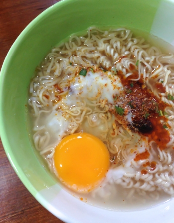 instant noodle with raw egg in a bowlの写真素材