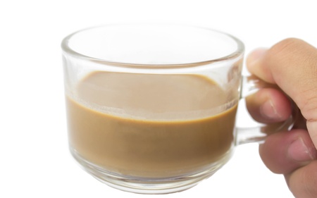 Hand holding glass cup of coffee on white backgroundの写真素材