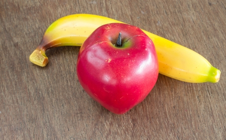 Apple and banana on the wooden tableの写真素材