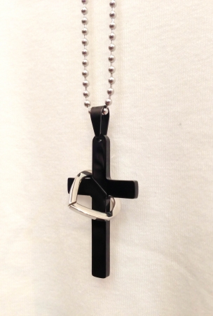 The ring be hold of the cross with necklace on backgroundの写真素材