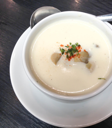 photo of delicious mushroom cream soup with parsleyの写真素材