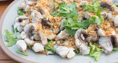 Poached fish cockle with coriander and braised leeksの写真素材