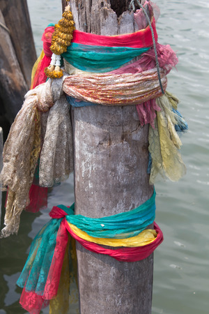 Three colors fabric around the tree  In Thailand, there are some believing about ghost or sacred things の写真素材