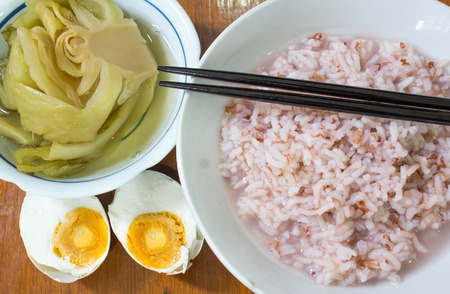 gruel and salted egg  and canned Vegetablesの写真素材
