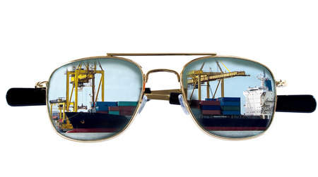 Reflection of container cargo freight ship in sunglasses