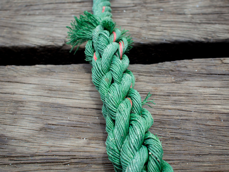 Green nylon twine is old Rope on wood backgroundの写真素材