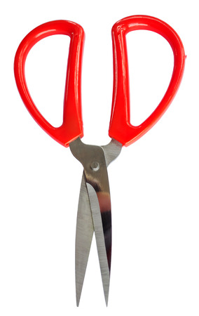 Red scissors are used for cutting various thin materials. Object is isolated on white backgroundの写真素材