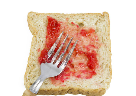 bread with strawberry jam with fork on white backgroundの写真素材