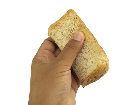 Bread slice in hand isolated on whiteの写真素材