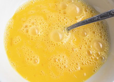 beaten eggs in a bowlの写真素材