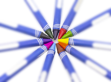 Colorful crayons roughly aligned in front of viewer on white backgroundの写真素材