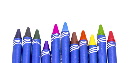 Colorful crayons roughly aligned in front of viewer on white backgroundの写真素材