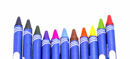 Colorful crayons roughly aligned in front of viewer on white backgroundの写真素材