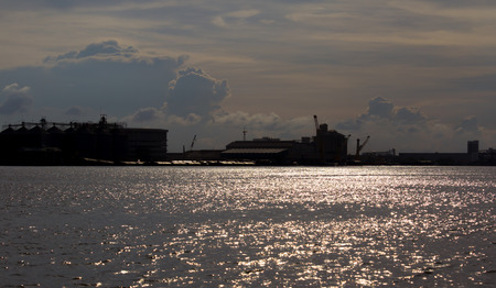 Sunset evening over river with strong sun reflection on water at Portの写真素材