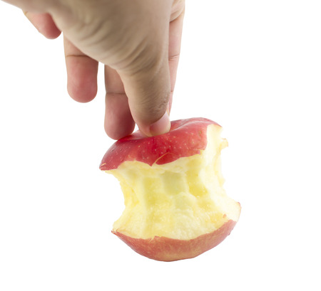 Bite red apple core in hand on a white backgroundの写真素材