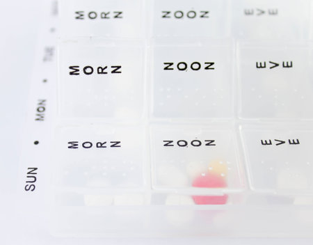Daily and Weekly pill box with selection of medicationの写真素材