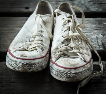 Old sneakers on the wooden floorの写真素材