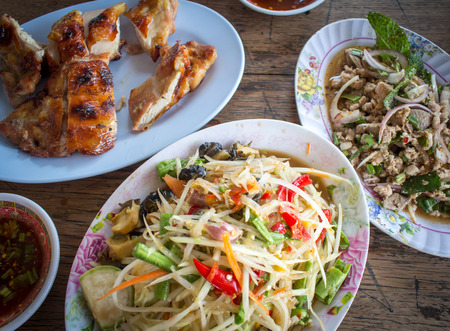 Thai food green papaya salad and grilled Chickenの写真素材