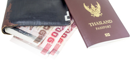 Thailand passport and Thai money in wallet old on white backgroundの写真素材
