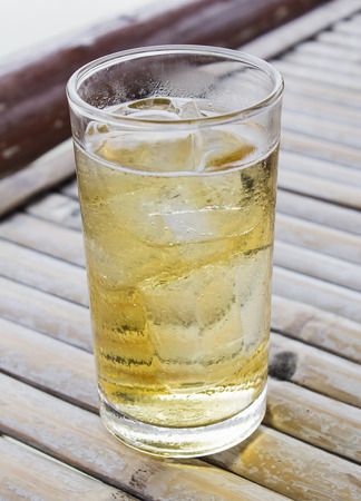 alcoholic beverage and ice on table woodenの写真素材