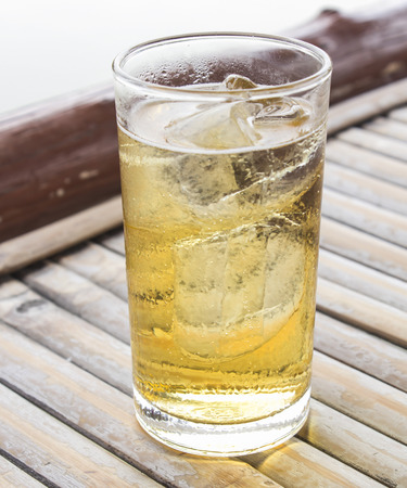 alcoholic beverage and ice on table woodenの写真素材