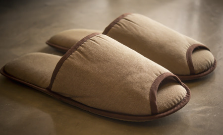 Pair of brown shoes for in room on cement floor in bed roomの写真素材