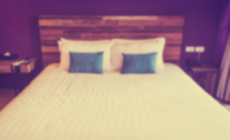 White and blue pillows on a bed ,Image blur retro toneの写真素材