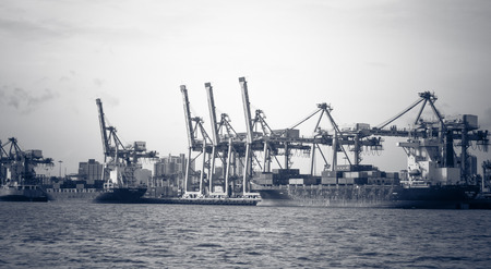 Container ship entering port with sunset time,tone black and white