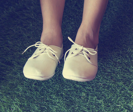 White shoes on grass background,retro style