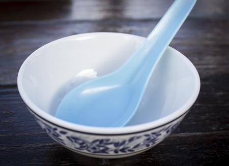 white bowl with blue spoonの写真素材