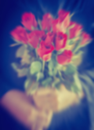 Bouquet of roses in hand,image blurの写真素材