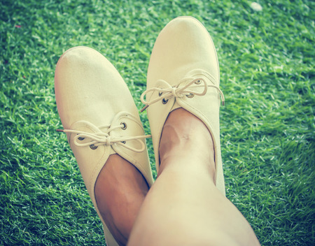 White shoes on grass background,retro styleの写真素材