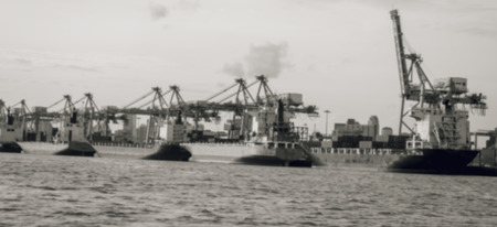 container ship entering port with sunset time,Image blur is tone black and whiteの写真素材