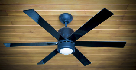 ceiling fan on a wooden ceilingの写真素材