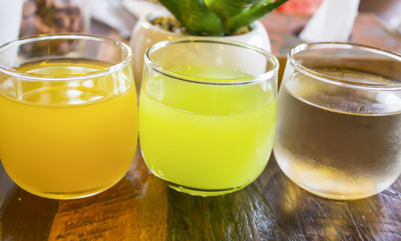 Three glass of juice on table woodの写真素材