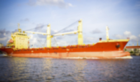 container ship entering port on blue sky backgroundの写真素材