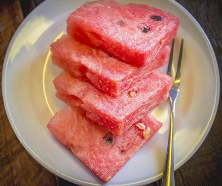 Slices of watermelon on white dishの写真素材