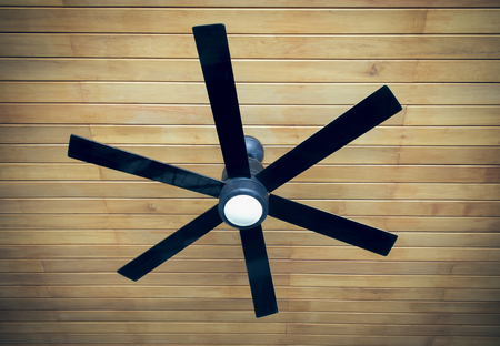ceiling fan on a wooden ceilingの写真素材