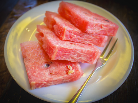 Slices of watermelon on white dishの写真素材