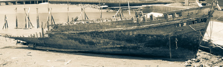 An old shipwreck or wrecked boat abandoned stand on the coast ,picture style black and whiteの写真素材