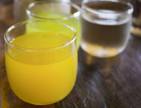 Three glass of juice on table woodの写真素材