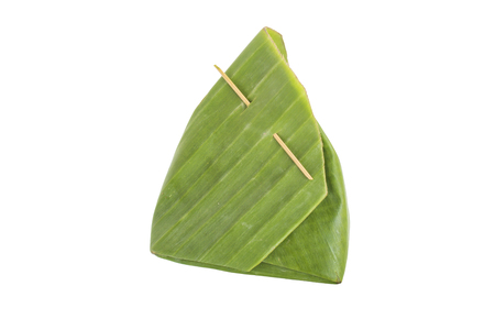 Thai dessert,  wrapped with banana leaf isolated on white backgroundの写真素材
