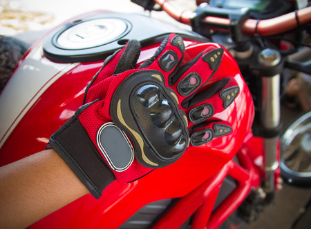 Close up red motorcycle gloves on a seat of  motorbike.の写真素材