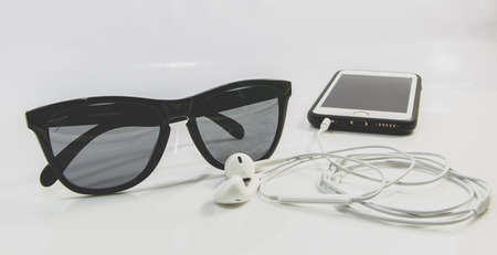 Sunglasses and smartphones on white backgroundの写真素材