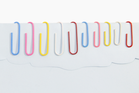 Colorful paper clips for office usage on white backgroundの写真素材