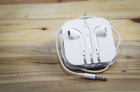 White earphone on wooden backgroundの写真素材