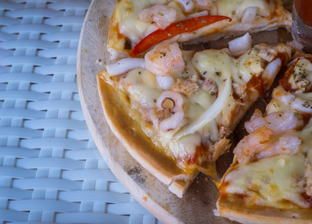 Pizza with seafood on tableの写真素材